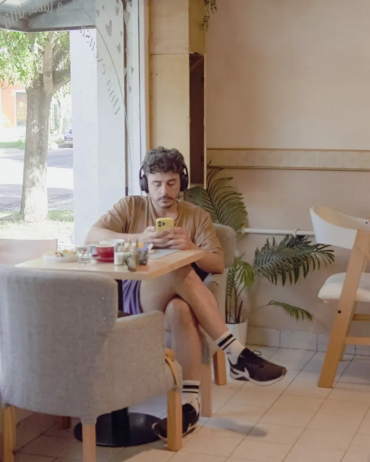 Un cliente con auriculares tomando algo en el salón